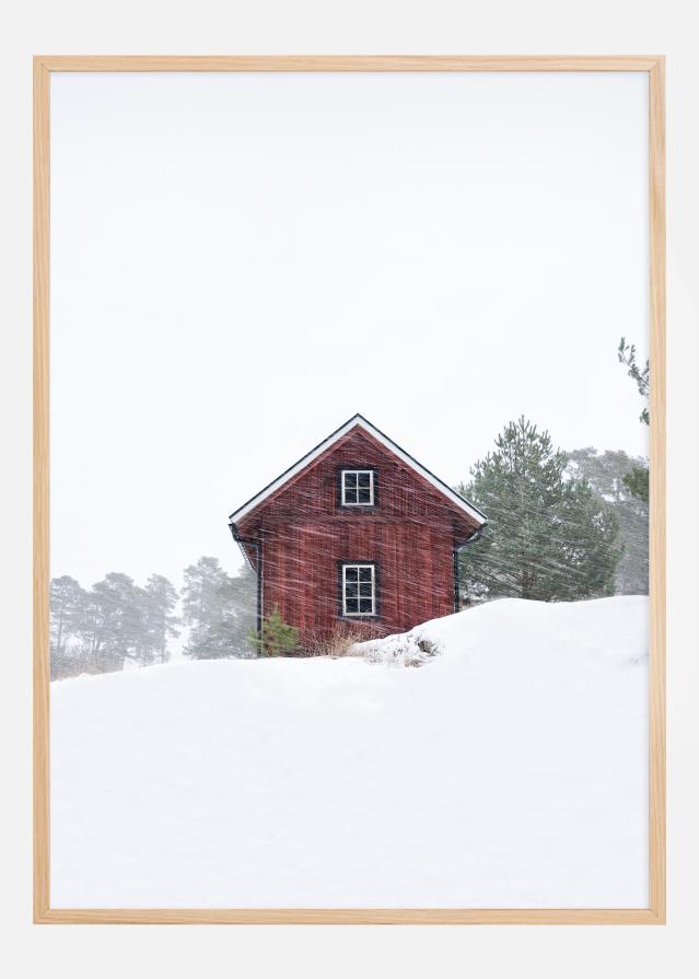 Old red house during snowstorm Plakāts